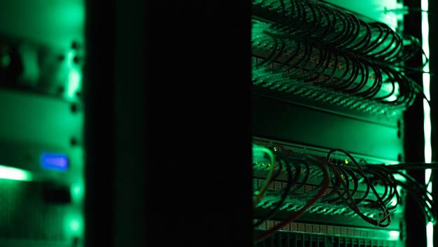 A server room with glowing blue lights representing high-tech ERP infrastructure and data storage