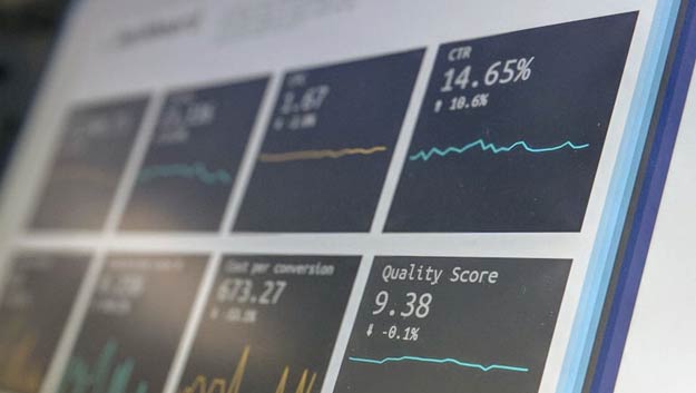 Close-up of a computer screen showing complex business data charts and modular software interfaces