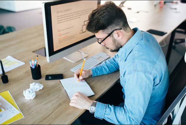 Developer writing custom code for ERP customization in office