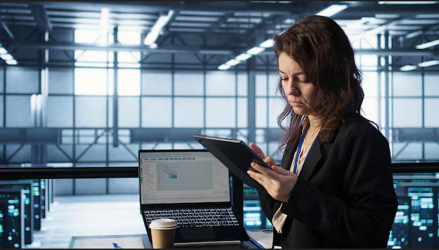 Employee using ERP system on tablet remotely through cloud