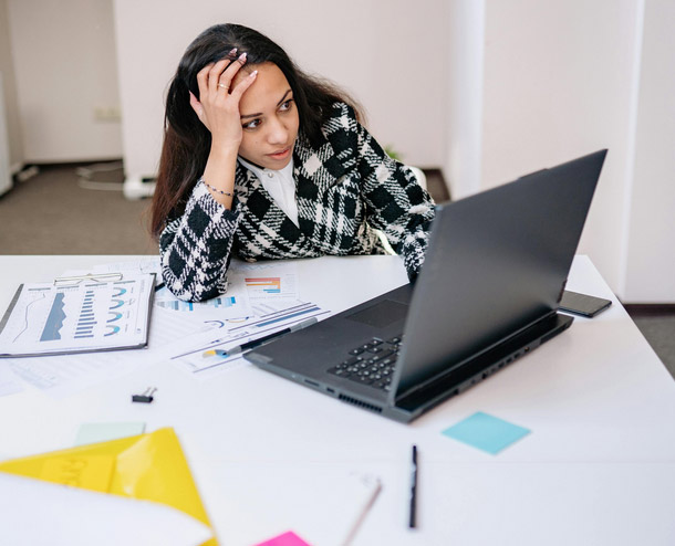 frustrated employee entering manual entries in a accounting software