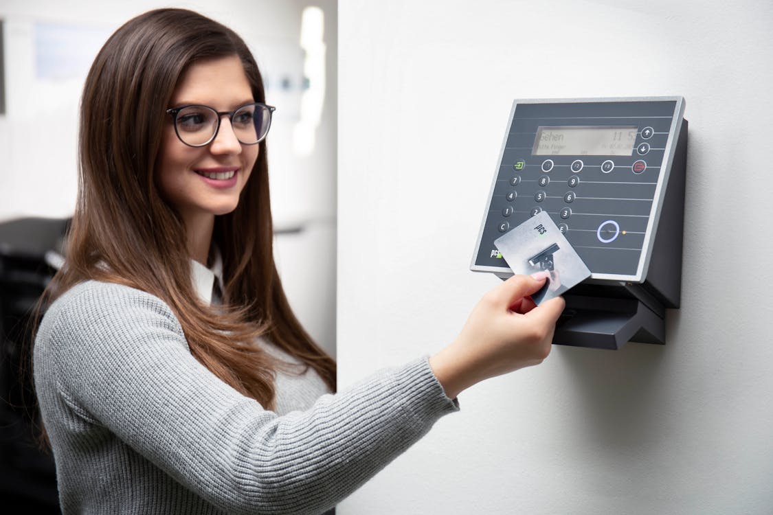 woman logging in the office using a time card