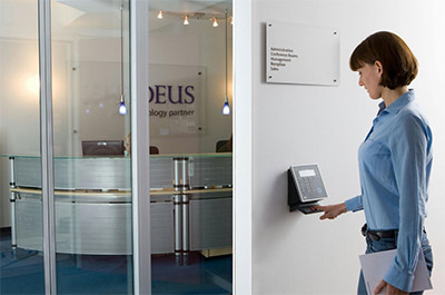 woman scanning her fingerprint to mark her attendance at work
